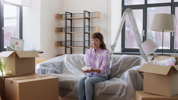 Happy Woman with Foam Peanut Moving to New Home alt