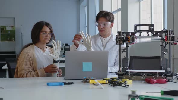 Teachers Explains to the Pupil How Work 3D Printed Hand alt