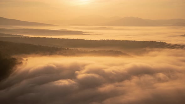 Stunning Time Lapse of Drifting Clouds During Warm Morning Light on a Sunrise Over Mountains