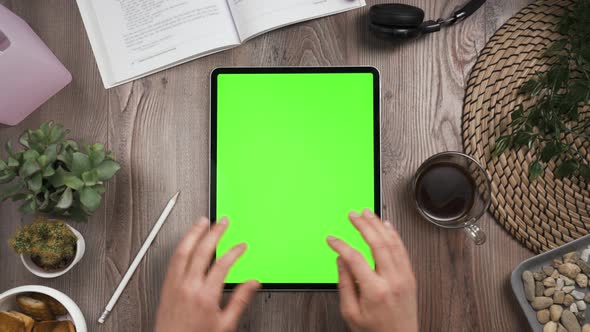 Vertical Orientation Tab with Green Screen. Top View. Hands Typing Message.