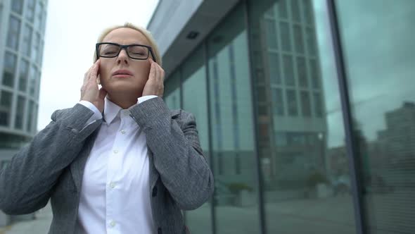 Old Female Office Head in Eyeglasses Suffering Migraine, Taking Painkillers