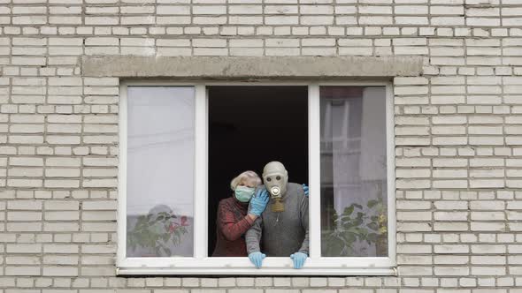 Old Grandparents Stay at Window Isolated at Home on Quarantine. Coronavirus alt