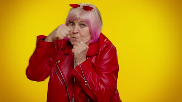 Funny Senior Granny Woman Trying to Fight at Camera Shaking Fist Boxing with Expression Punishment alt