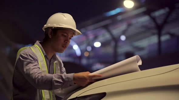 Civil engineer work inspecting architect drawing on construction site