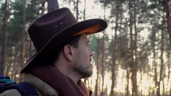 A Man with a Hat in the Forest alt