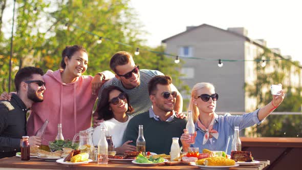 Happy Friends Taking Selfie at Rooftop Party 15 alt