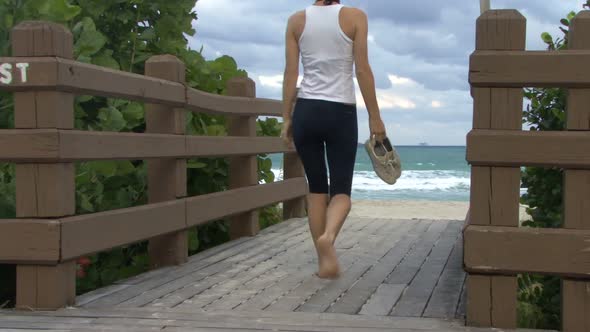 Female walking onto beach alt