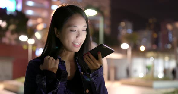 Woman work on cellphone at night alt