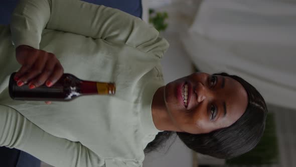 Vertical Video Afro American Woman Talking with Her Friends Holding Beer Bottle alt