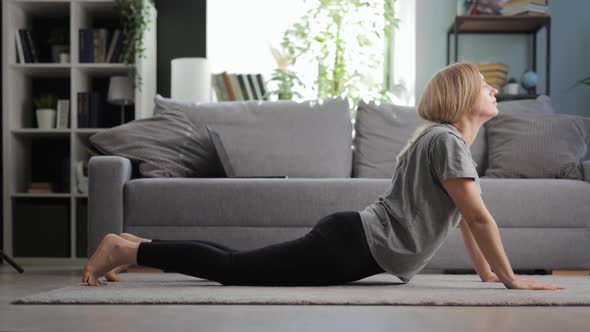 Woman Stretching Body on Floor