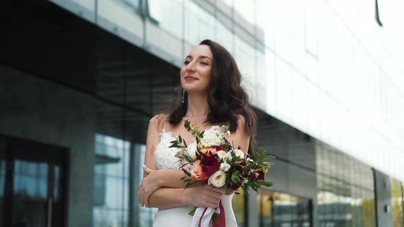 Bride is Walking in Big City Beside Business Center Mall