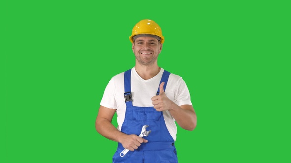 Worker with wrench showing thumb up and smiling to camera alt