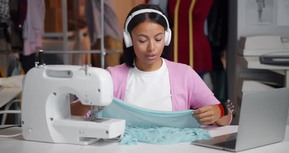 Female Fashion Designer in Studio Meeting with Client Via Video Call on Laptop alt