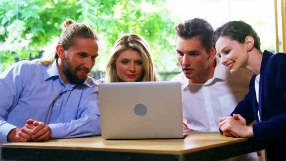 Happy friends using laptop alt