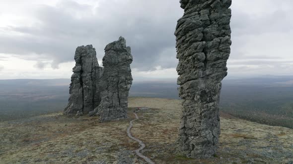 Aerial view of breathtaking stone pillars on the top of a hill alt