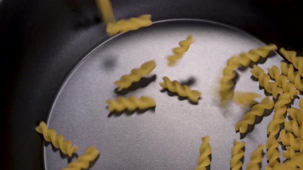 Pasta being poured into a pot