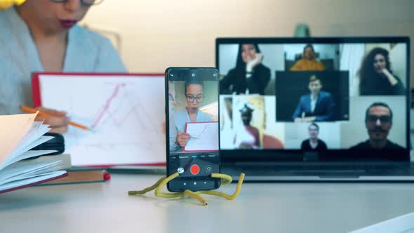 Online Conference with a Woman Giving Explanation During It alt