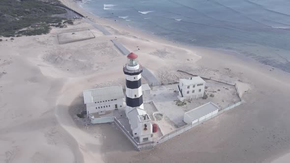 Drone Orbiting Around Lighthouse with Ocean in Background