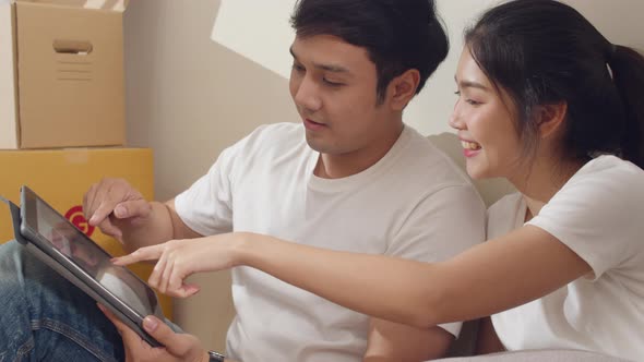 Korean family use digital tablet discuss interior design renovation ideas. alt