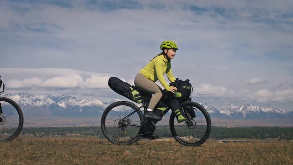 The Man and Woman Travel on Mixed Terrain Cycle Touring with Bikepacking alt