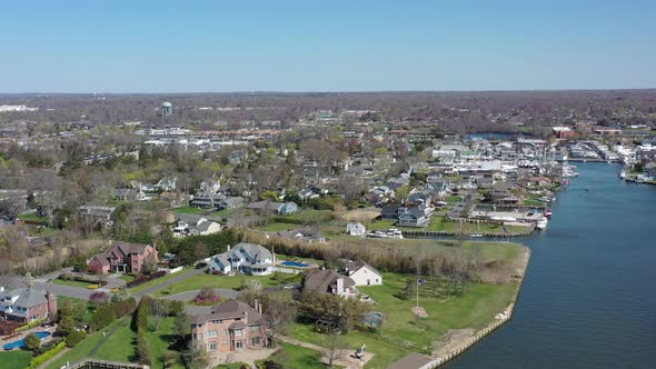 A high angle drone view over Bay Shore, NY, on a sunny day with clear skies. The camera dolly in ove alt