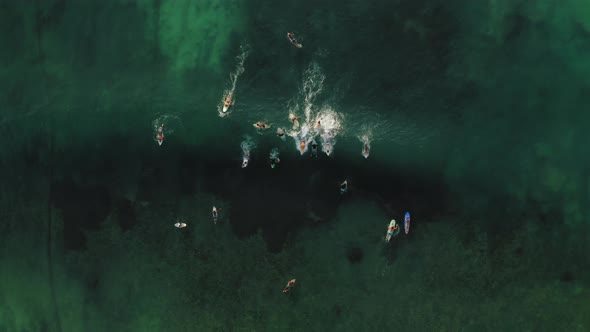 Aerial Drone Flight Over Surfers on the Wave Bali Indonesia alt