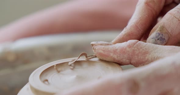 Female Potter Sitting and Makes a Cup on the Pottery Wheel. Woman Making Ceramic Item. Pottery alt