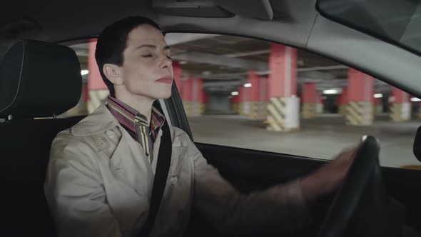 Cheerful Woman Looking for Parking Space alt