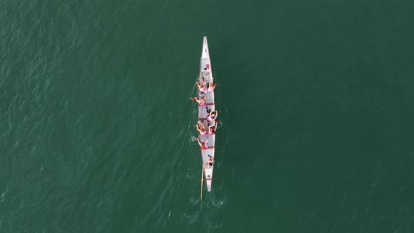 Aerial drone bird's eye view video of sport canoe operated by team of young clear waters.