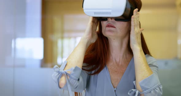Businesswoman using virtual reality headset in a modern office 4k