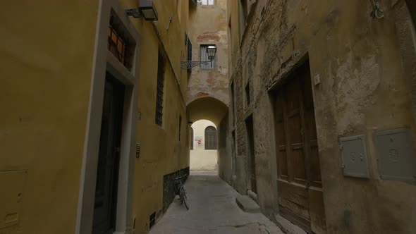 A corridor between two old buildings alt