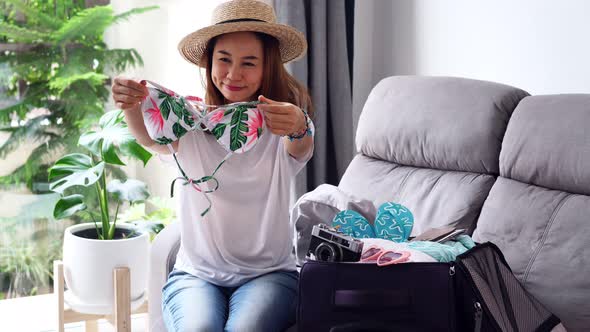 Young asian woman traveler preparing for the summer vacation