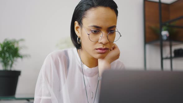 Close Up Portrait of Mixed Race Modern Woman Working with Laptop at Home alt