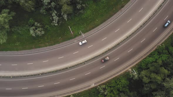 Traffic on a Stretch of Curved Road in a Protracted Turn  Top View Drone Shot alt