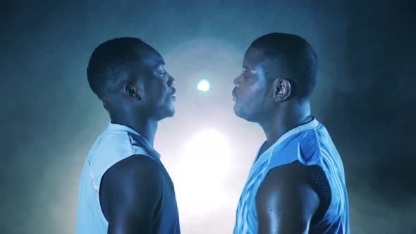 Two African Players are Looking Defensively at Each Other alt