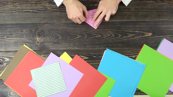 Hands Making Origami, Top View. alt