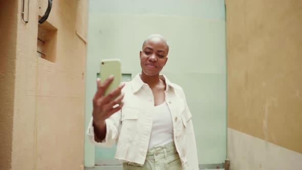 Slow motion shot of happy woman making a video with her smartphone alt