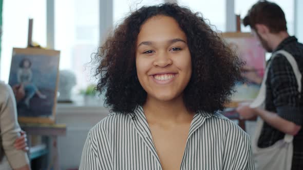 Slow Motion Portrait of Cute Mixed Race Girl Model Smiling Posing in Art Classes alt