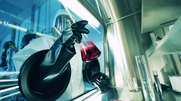 Conical Flask with Liquid is Getting Analyzed Inside of a Vacuum Cabinet alt