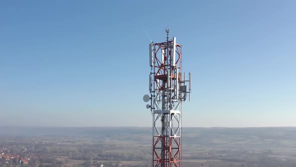 Red and white metal of telecommunication antenna tower 4K drone video alt