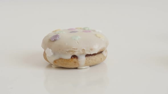 Glazed  teacake  stuffed with cream slow tilt 4K 2160p 30fps UltraHD footage - Decorative sprinkles  alt