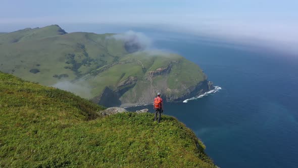 Traveler Standing on Edge of Shikotan Island and Looking on Pacific Ocean, Russia