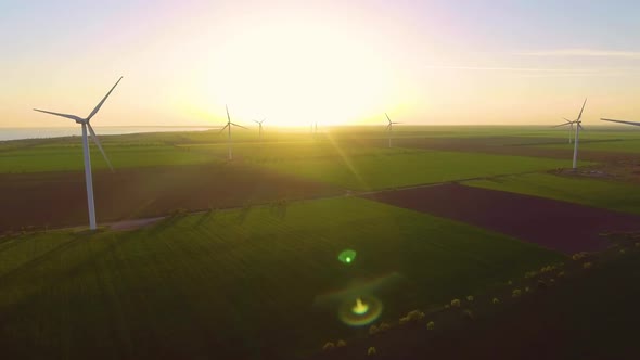 Wind Turbine Farm on Beautiful Evening Landscape. Renewable Energy Production for Green Ecological