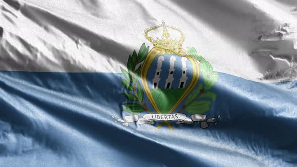 San Marino textile flag waving on the wind. Slow motion. 20 seconds loop.  alt