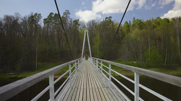 Suspension bridge over the river in spring
