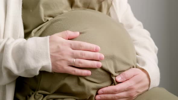 Pregnant Expectant Mother Caressing Her Belly alt