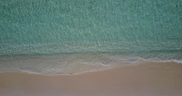 Beautiful birds eye copy space shot of a white sand paradise beach and aqua blue ocean background in alt