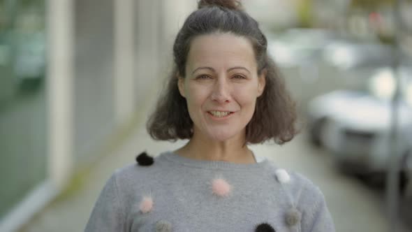 Joyful Middle Aged Woman Talking To Camera. alt