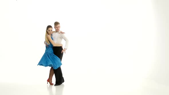 Couple of Graceful Dancers Perform Tango on White Studio Background alt