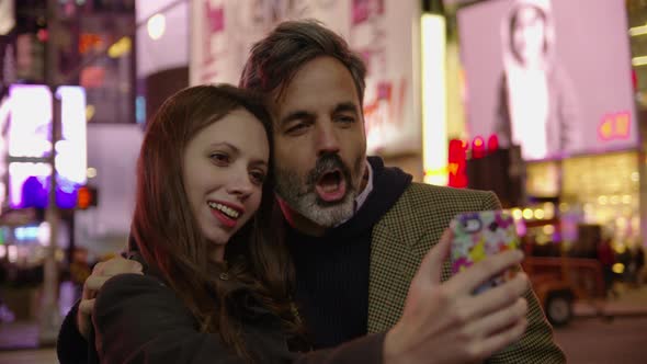 Couple taking selfie in Times Square, New York City